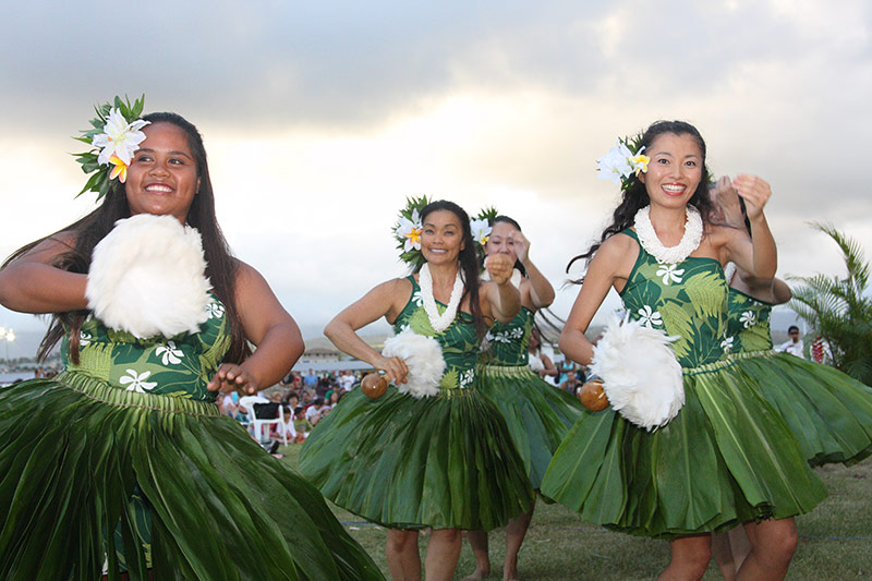 Four dancers in hula skirts.